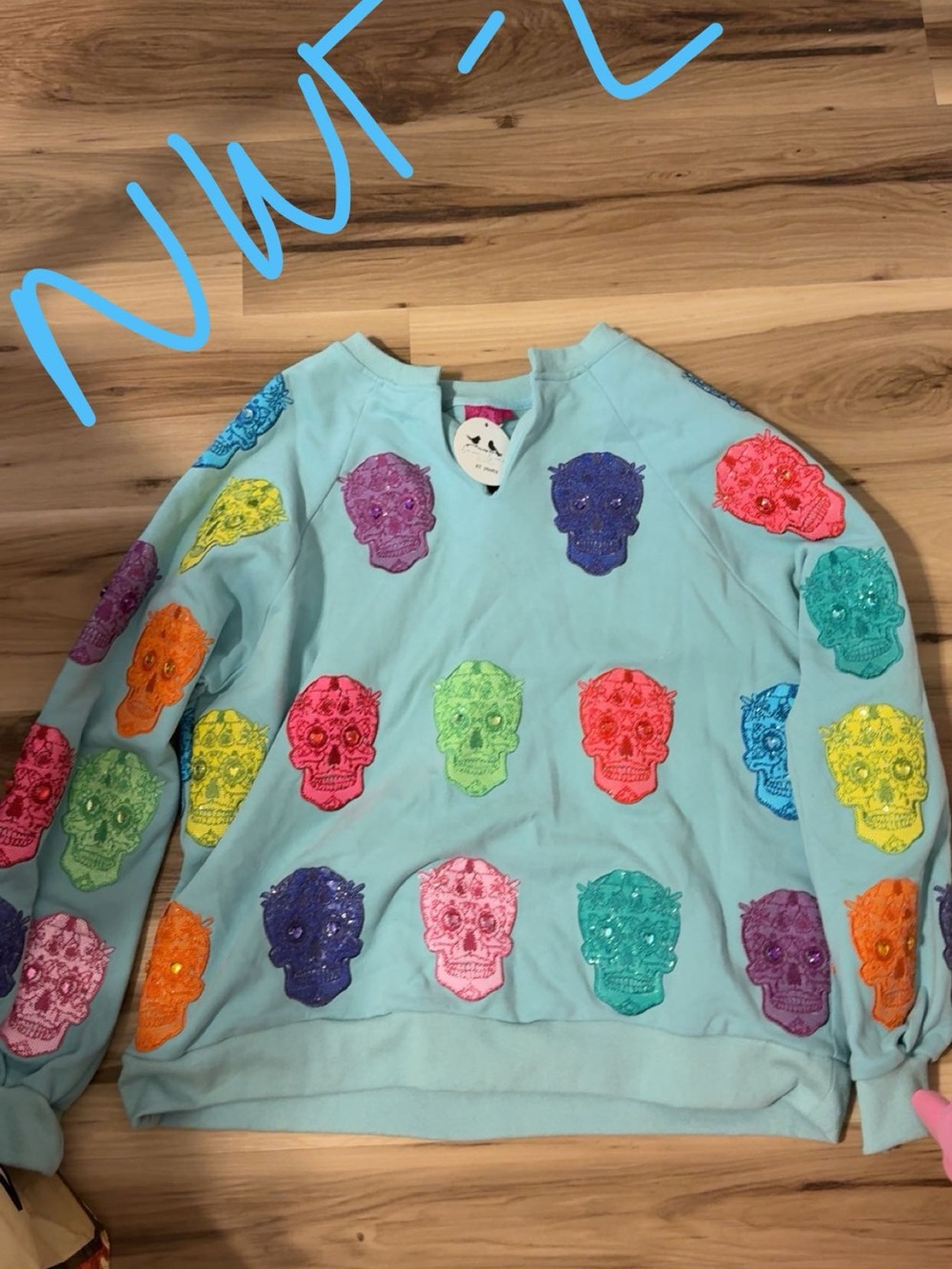 QUEEN OF SPARKLES Light Blue Sweater with Multicolor Skull Appliqués
